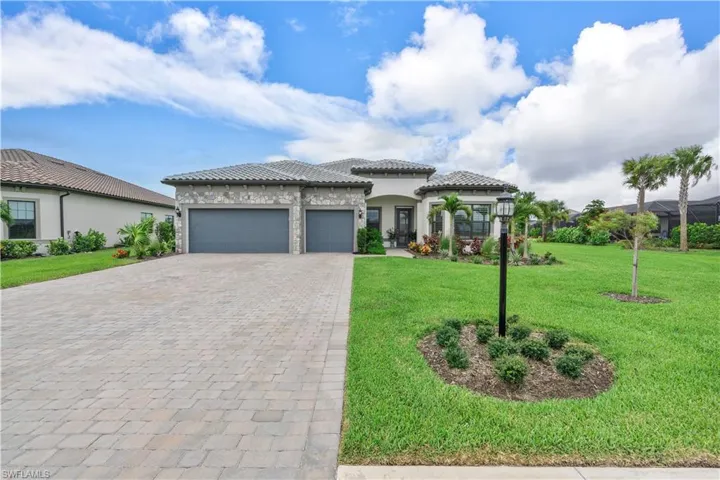 View of front of house with a garage and a front yard