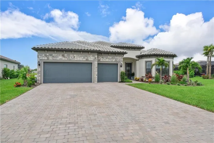 View of front of property with a garage and a front yard