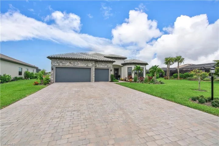 View of front of home with a front lawn and a garage