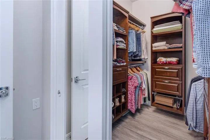 Primary bedroom walk-in closet with built-ins