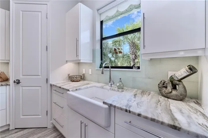 Large farmhouse sink and brushed granite counter tops