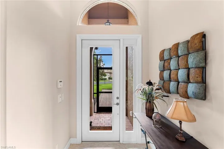 Entryway with light tile patterned floors