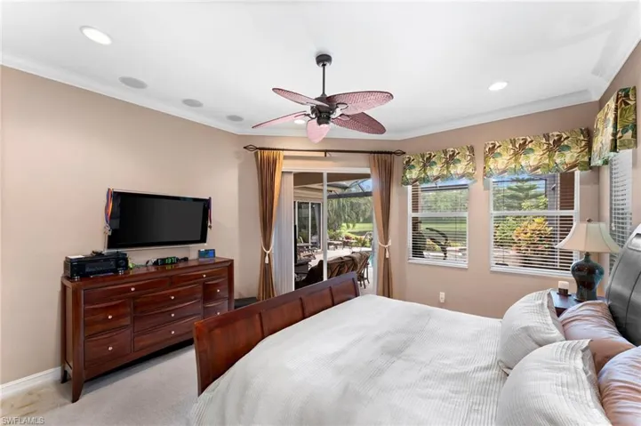 Bedroom featuring crown molding, access to outside, ceiling fan, and light colored carpet