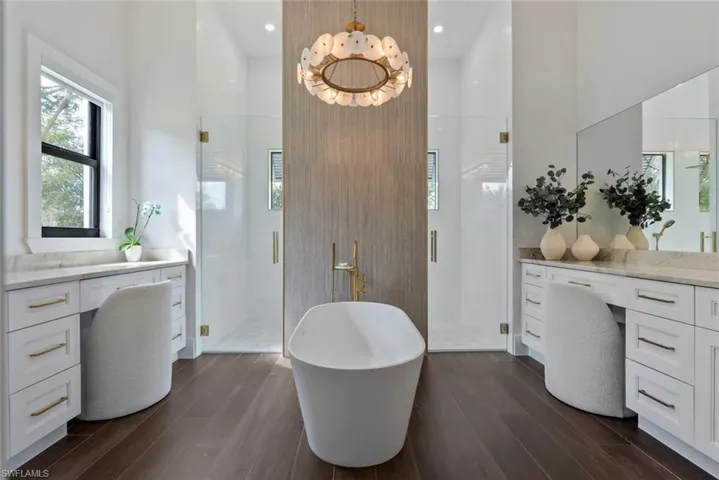 Bathroom featuring vanity, wood-type flooring, and separate shower and tub