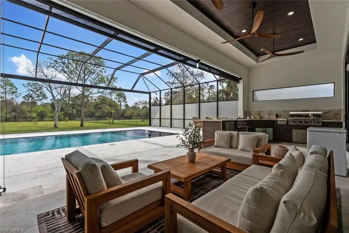 View of pool with a grill and ceiling fan