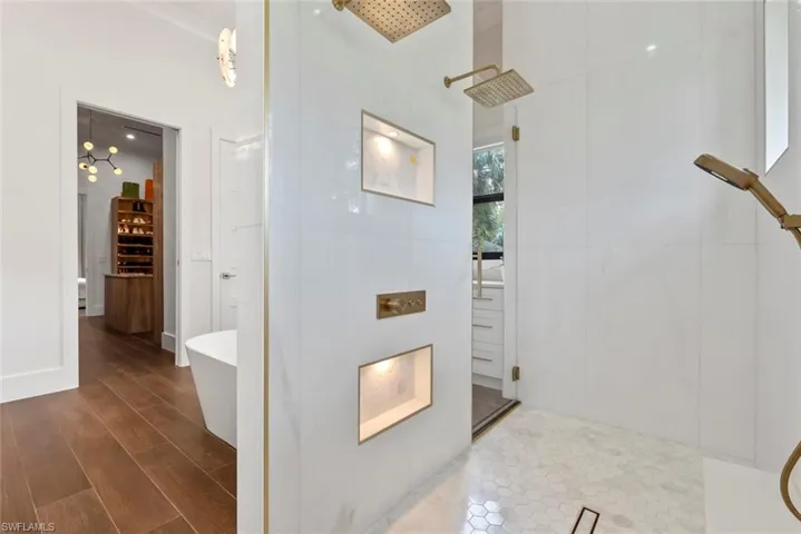 Bathroom featuring hardwood / wood-style floors and independent shower and bath
