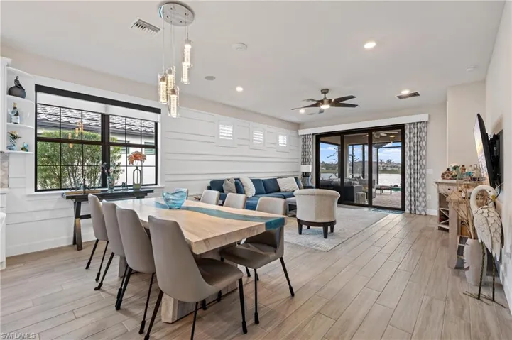Dining space featuring ceiling fan, plenty of natural light, and light wood-type flooring