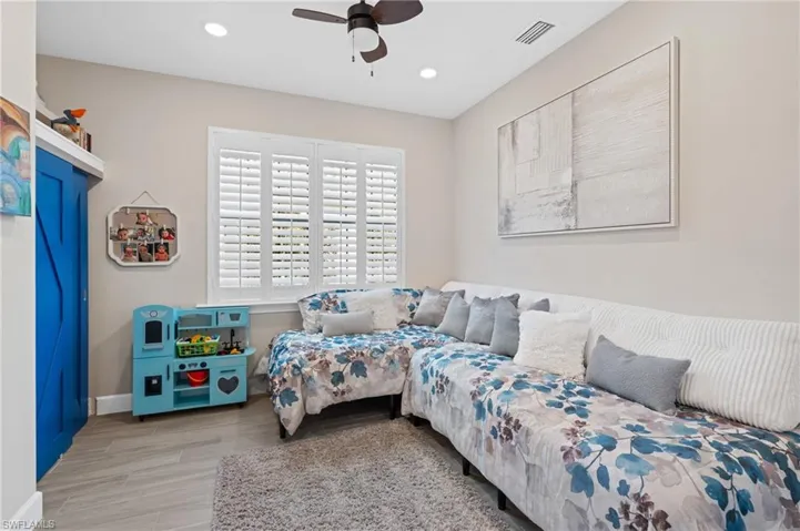 Bedroom featuring ceiling fan and light hardwood / wood-style flooring