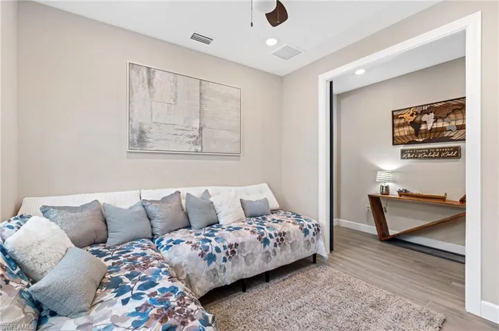 Living room with ceiling fan and light hardwood / wood-style floors