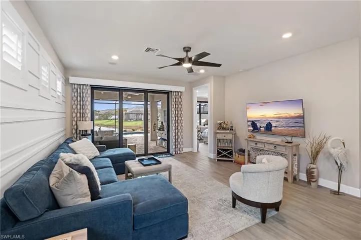 Living room featuring ceiling fan and light wood-type flooring