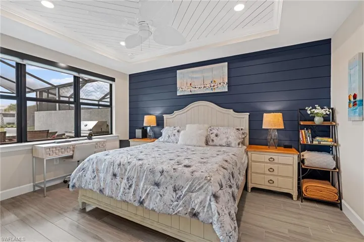 Bedroom featuring crown molding, wood ceiling, light hardwood / wood-style flooring, and ceiling fan