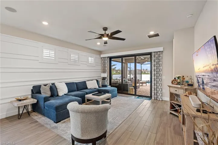 Living room featuring ceiling fan and light wood-type flooring