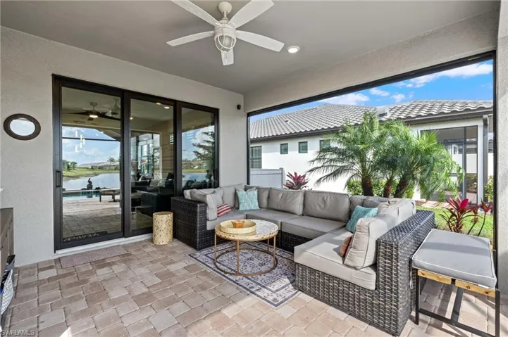 Sunroom / solarium with a water view and ceiling fan