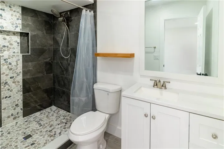 Bathroom with vanity and a tile shower