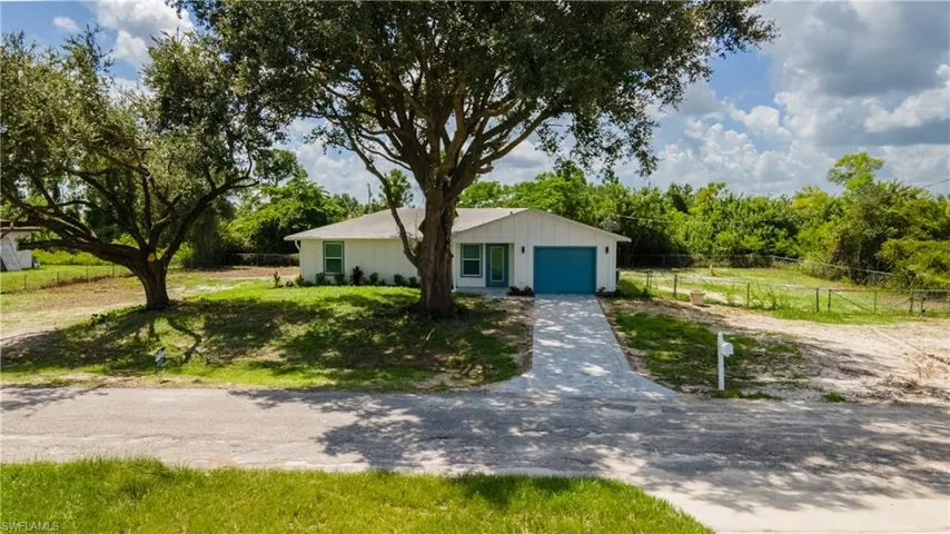 View of front facade with driveway and a garage