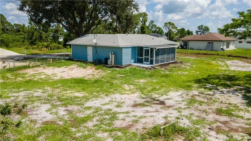 Rear view of property with a sunroom