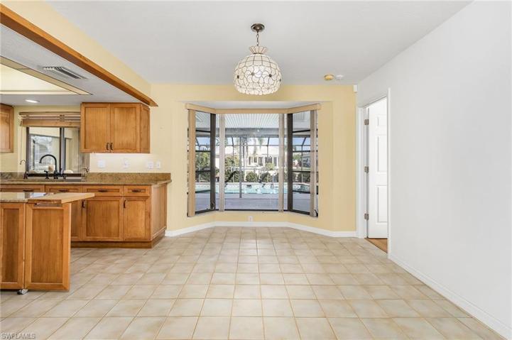 Dining area with bay window w/pool and water view