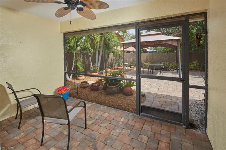 Large screened lanai opens to the tiled patio area.