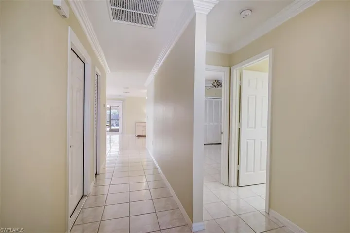 Entry hallway. Two bedrooms and a bath to the right. The living area and primary are in the rear of the home.