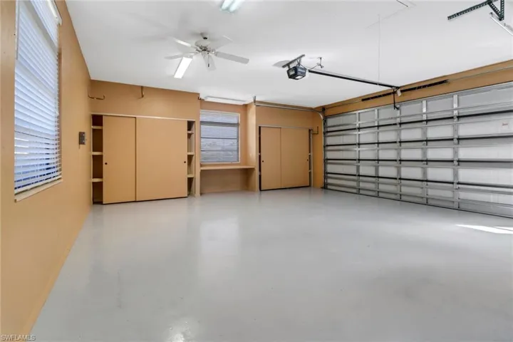 Garage with ceiling fan and a garage door opener