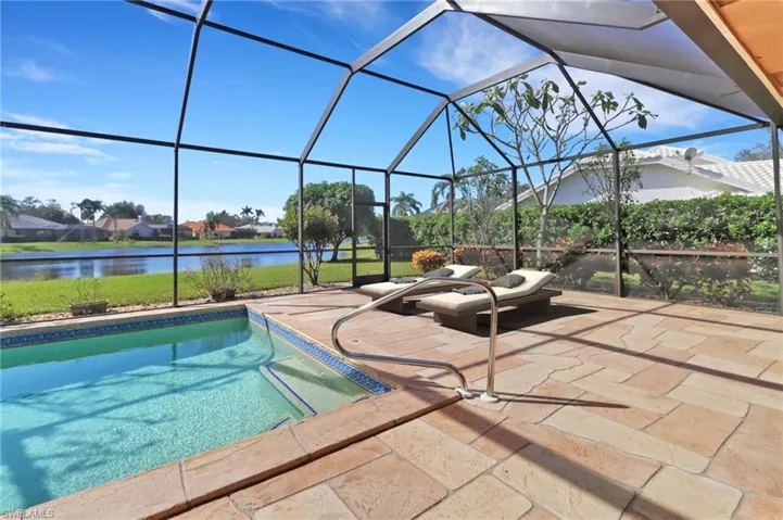 View of pool featuring a patio area, and a water view
