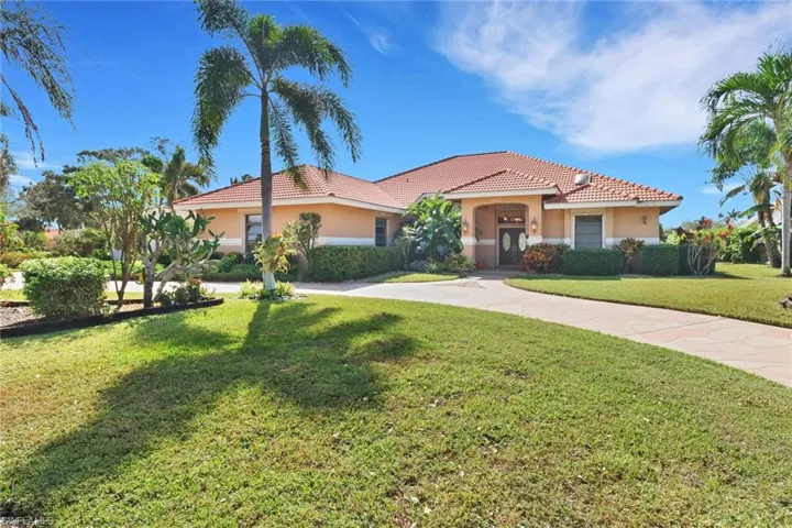 Mediterranean / spanish-style house with a front lawn
