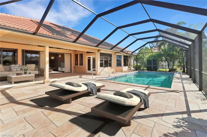 View of swimming pool featuring a lanai, a patio, and an outdoor hangout area
