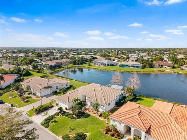 Birds eye view of property with a water view