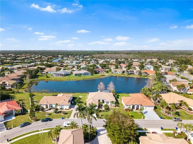 Birds eye view of property with a water view