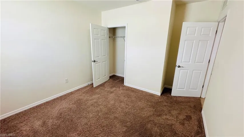 Unfurnished bedroom featuring carpet floors and a closet