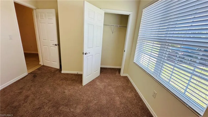 Unfurnished bedroom featuring carpet and a closet