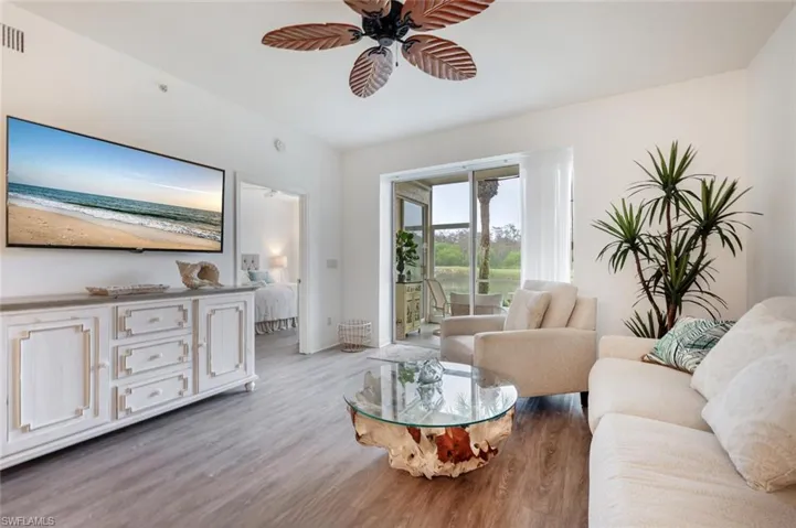 Living room featuring ceiling fan and light hardwood / wood-style flooring