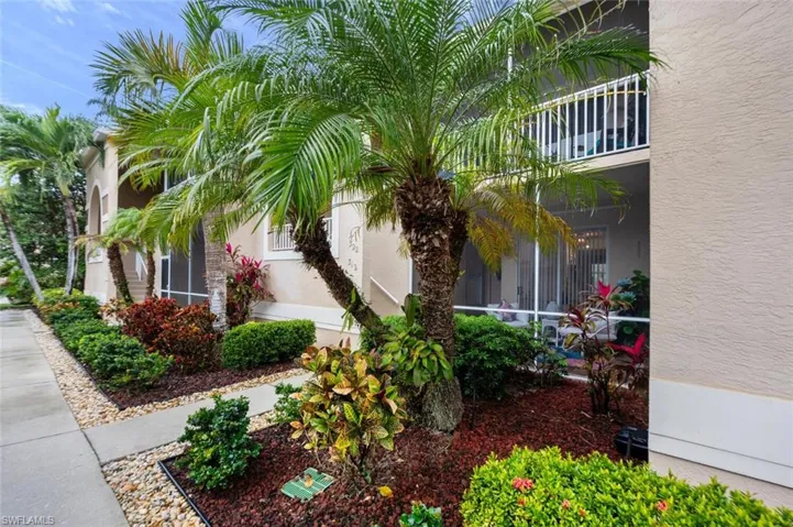 View of side of home featuring a balcony