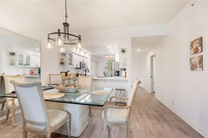 Dining space with sink and light hardwood / wood-style flooring