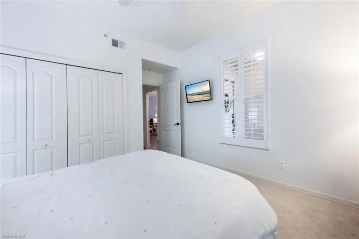 Bedroom featuring a closet, ceiling fan, and carpet