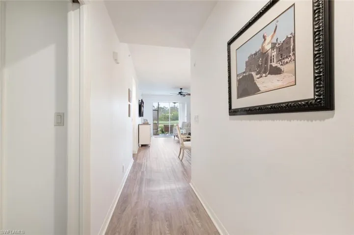 Corridor with hardwood / wood-style flooring