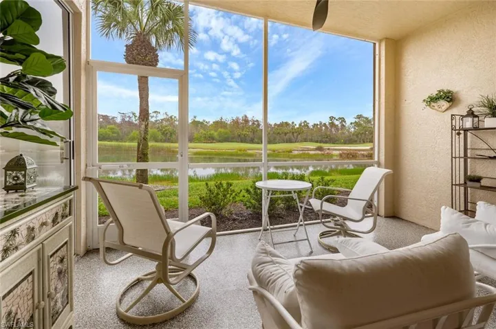 Sunroom featuring a water view