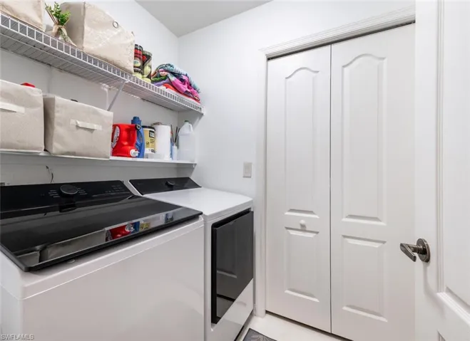 Laundry area featuring washing machine and clothes dryer
