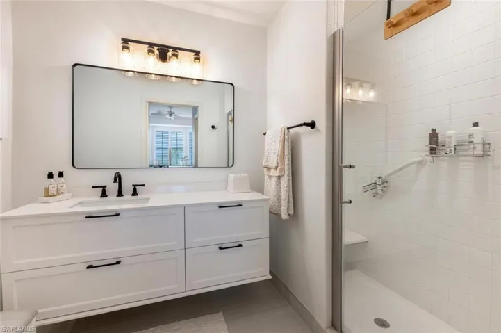 Bathroom featuring walk in shower and vanity
