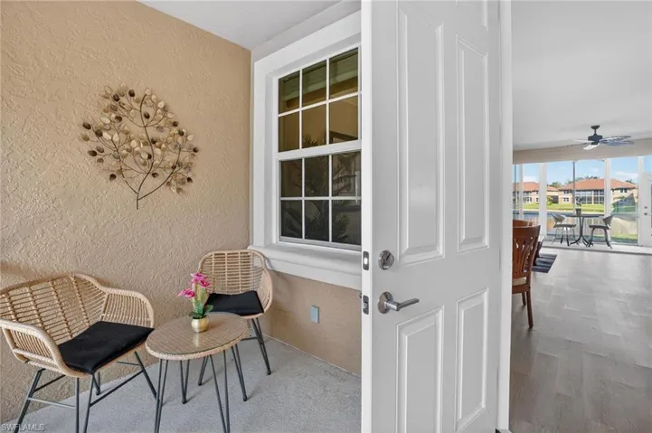 Property entrance with ceiling fan, stucco siding, and a patio area