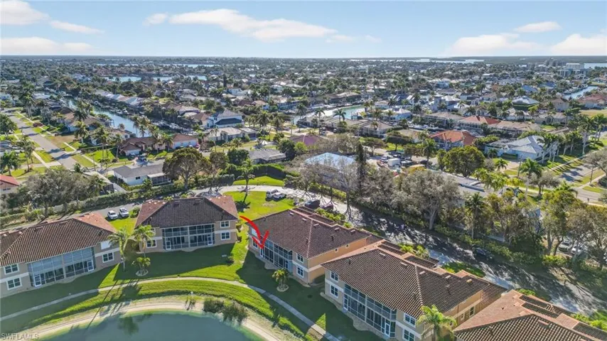 Aerial view of property and surrounding area featuring nearby suburban area