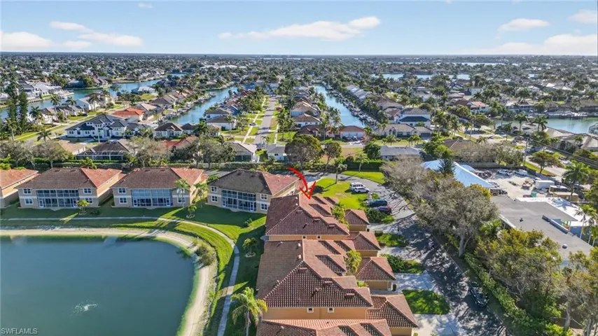 Aerial overview of property's location with a large body of water and nearby suburban area