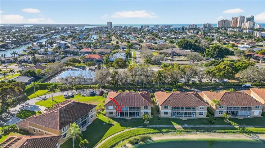 Aerial view of property and surrounding area with nearby suburban area