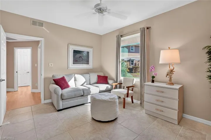 Living room featuring ceiling fan and light tile patterned floors