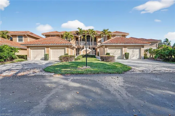 Mediterranean / spanish-style house with stucco siding, a tiled roof, and a front yard