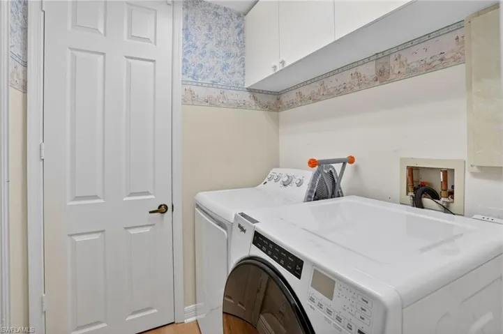 Laundry area with cabinet space and washing machine and dryer