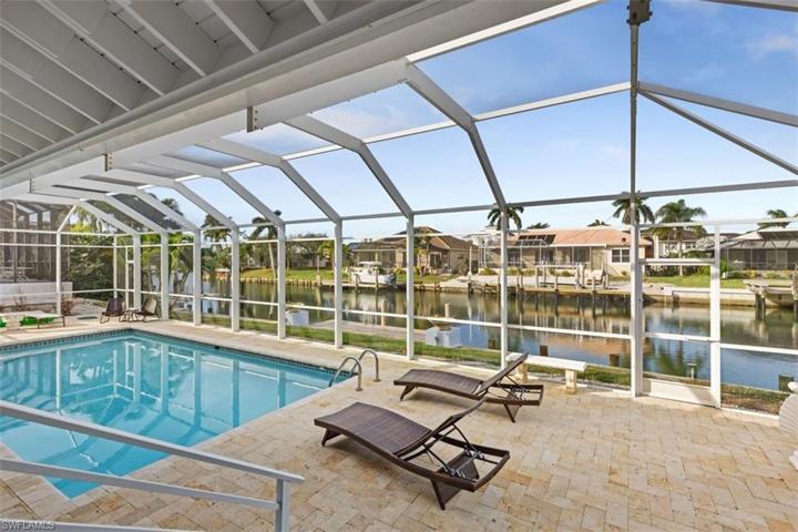 huge deck around spacious pool, overlooking the water