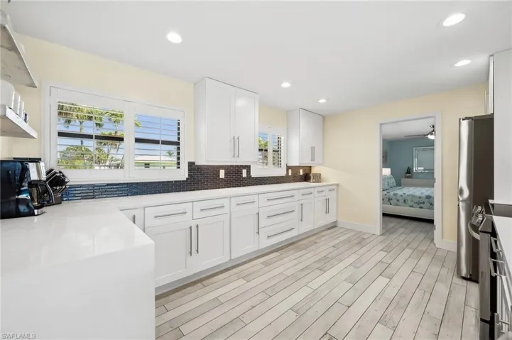 Remodeled kitchen with quartz countertops and waterfall edge