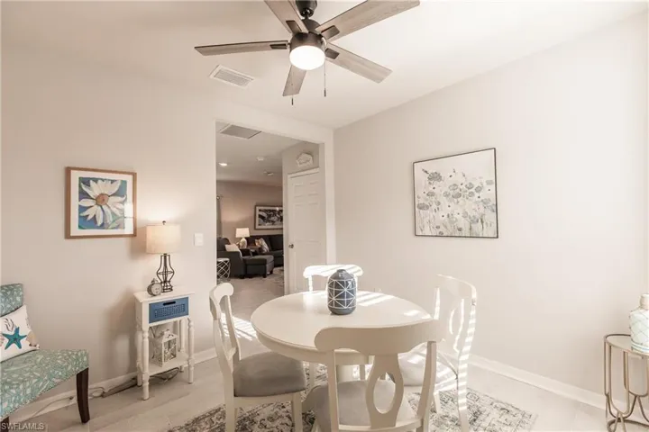 Dining room with ceiling fan.