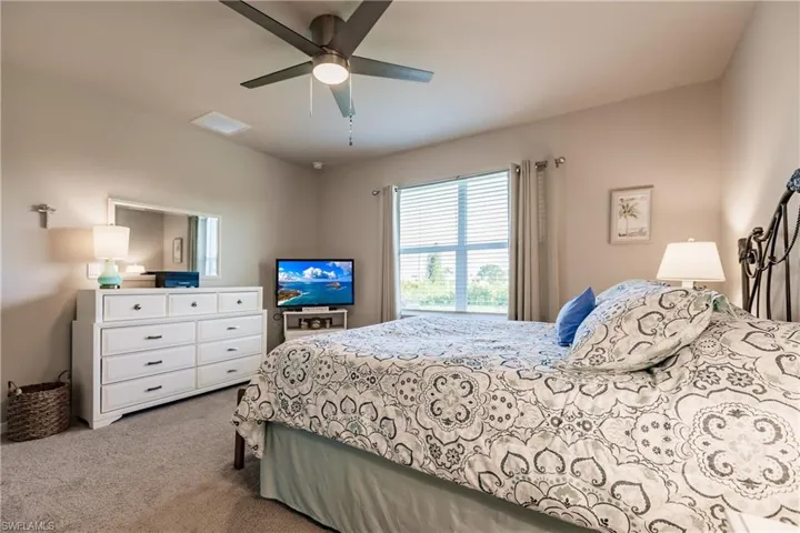 Primary Bedroom featuring ceiling fan and carpet